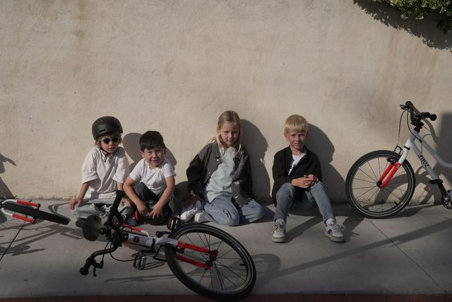 Kids taking a break with bikes during a cooperative outdoor play activity