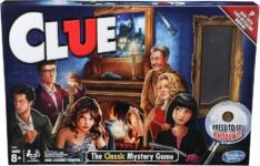 Clue board game box with mansion gameboard, six character pawns, miniature weapon tokens, suspect and room cards, yellow crime envelope, and detective notepad set up for a murder mystery.