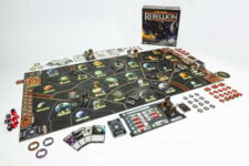 Star Wars: Rebellion board game set up on a table, showing the connected Core Worlds and Outer Rim maps, plastic Star Destroyer and AT-AT miniatures, leader cards, and combat dice.